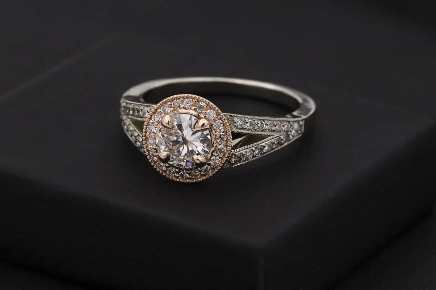 Representative rose gold jewelry image showing a rose gold and white diamond ring against a dark surface